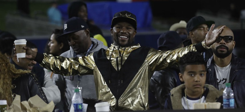 Boxer Floyd Mayweather Jr. reacts in the stands during an NFL football game Nov. 19 in Los Angeles.