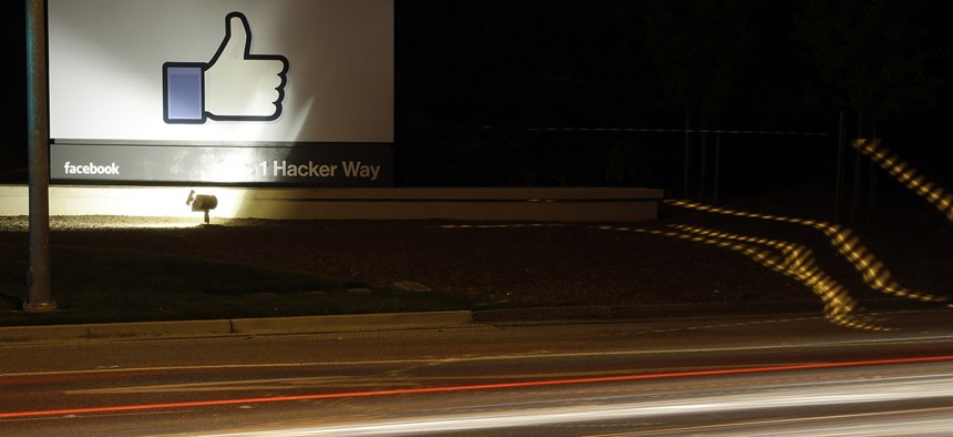 The Facebook "like" symbol is on display on a sign outside the company's headquarters in Menlo Park, Calif., Friday, June 7, 2013.