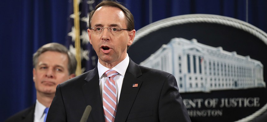 Deputy Attorney General Rod Rosenstein with FBI Director Christopher Wray, speaks during a news conference at the Justice Department in Washington, Thursday, Dec. 20, 2018