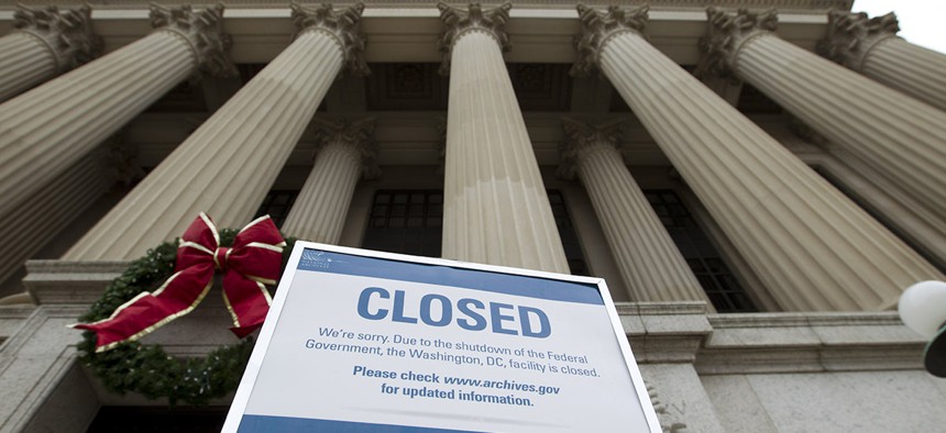 A closed sign is displayed at The National Archives entrance in Washington, Tuesday, Jan. 1, 2019, as a partial government shutdown stretches into its third week.