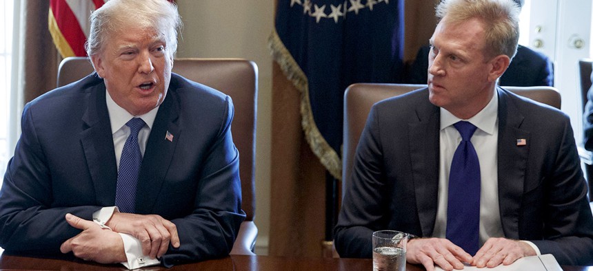 Deputy Secretary of Defense Patrick Shanahan, right, listen as President Donald Trump speaks during a cabinet meeting at the White House.