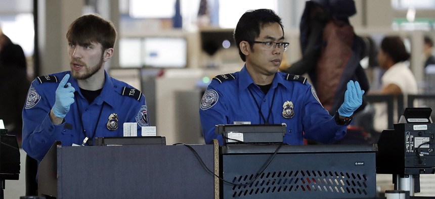 Transportation Security Administration officers work at a checkpoint at O'Hare airport in Chicago, Saturday, Jan. 5, 2019. 