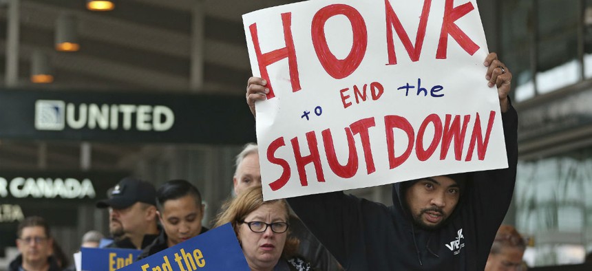More than two dozen federal employees and supporters demonstrate at the Sacramento International Airport calling for lawmakers to end the partial government shutdown. 