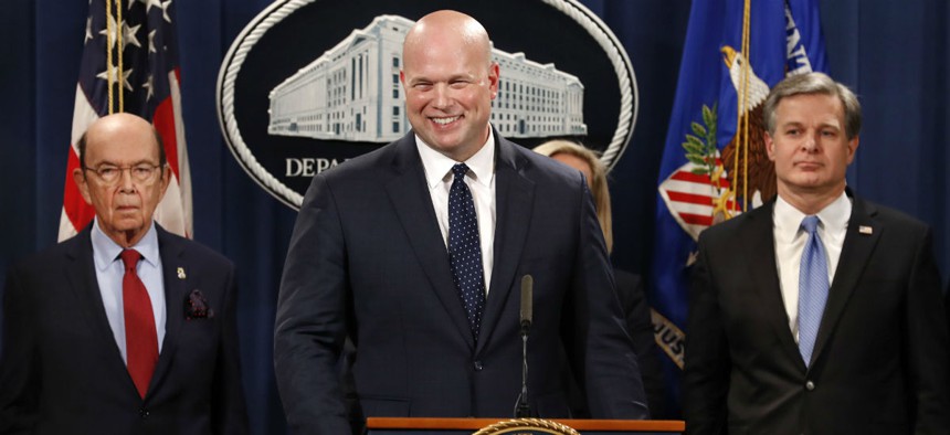 Acting Attorney General Matt Whitaker, center, announces an indictment of Chinese telecommunications companies including Huawei, on violations including bank and wire fraud Jan. 28 at the Justice Department in Washington. 