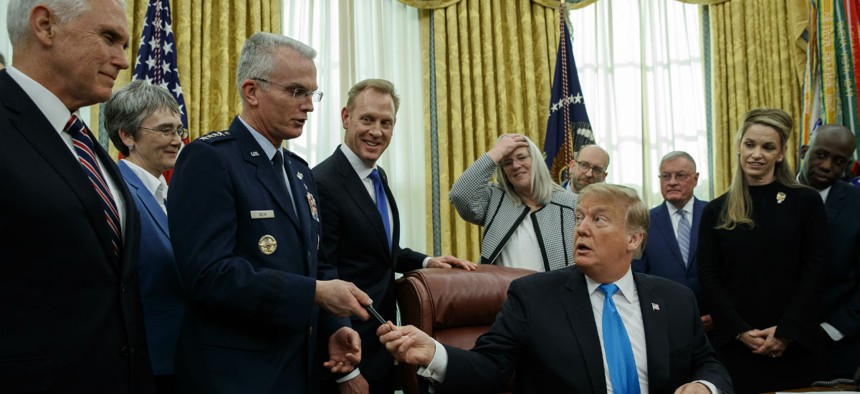 President Donald Trump hands a pen to Air Force Gen. Paul Selva after signing "Space Policy Directive 4" in the Oval Office of the White House Feb. 19.