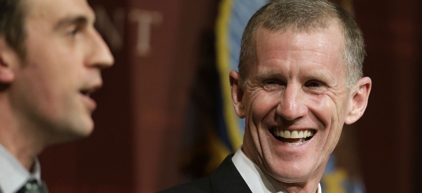 Retired U.S. Army Gen. Stanley McChrystal, right, reacts to moderator Daniel Feehan, left, at a forum at Harvard University in 2013.