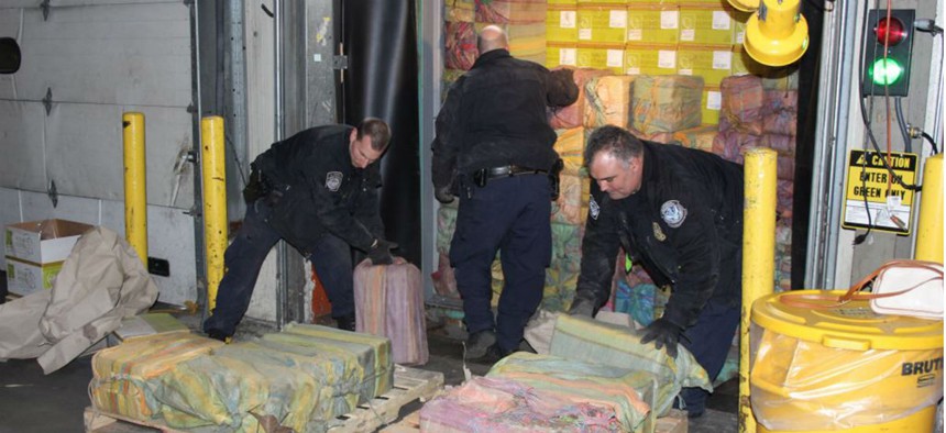 Customs agents unloading a truck containing 3,200 pounds of cocaine in 60 packages, where it was seized at the Port of New York/Newark, in Newark, N.J. 