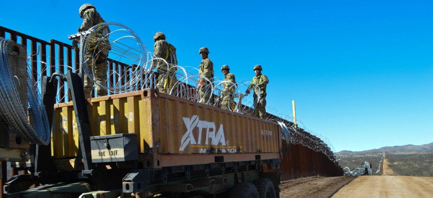 Engineers and military police welded rebar and emplaced single strand and concertina wire on the border wall in Sasabe, Arizona, in February.