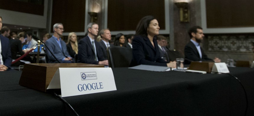 An empty chair reserved for Google's parent Alphabet, which refused to send its top executive, is seen as Facebook COO Sheryl Sandberg and Twitter CEO Jack Dorsey testify before the Senate Intelligence Committee Sept. 5.