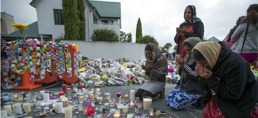 People mourn at a makeshift memorial site near the Al Noor mosque in Christchurch, New Zealand, March 19.