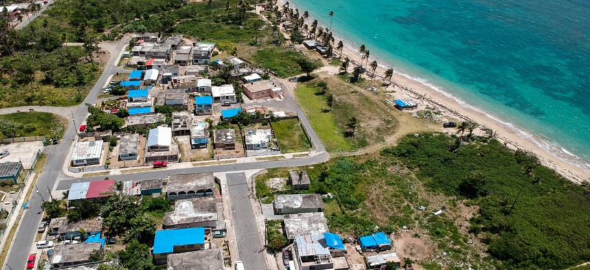 Blue tarps cover homes in Puerto Rico that were still damaged nine months after Hurricane Maria hit.