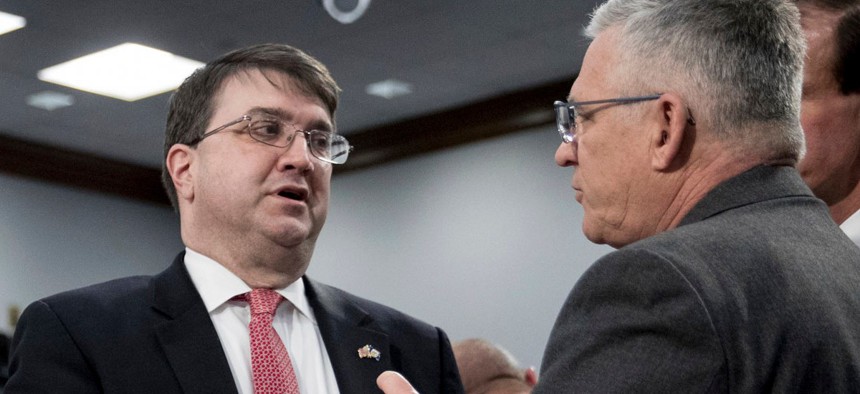 Veterans Affairs Secretary Robert Wilkie, left, speaks with Veterans Health Administration Executive in Charge, Dr. Richard Stone, right, before a House Appropriations subcommittee hearing on budget on March 27.