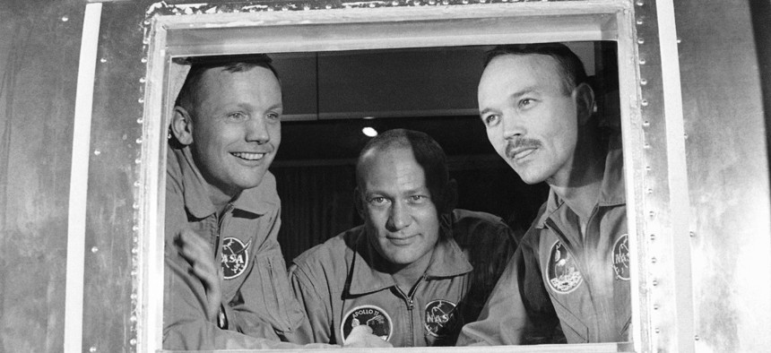 In this July 27, 1969 file photo, Apollo 11 crew members, from left, Neil Armstrong, Buzz Aldrin and Michael Collins sit inside a quarantine van in Houston.