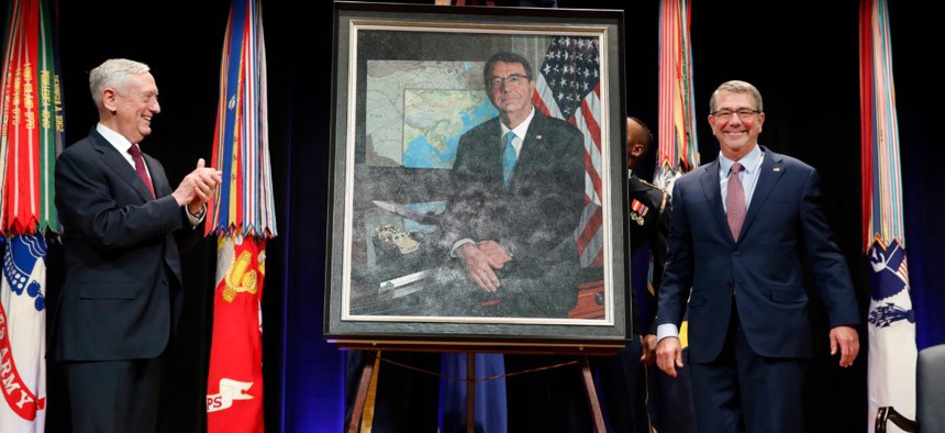 Then Defense Secretary James Mattis, left, applauds former Defense Secretary Ash Carter, right, during the portrait unveiling ceremony for the former secretary at the Pentagon in February 2018.