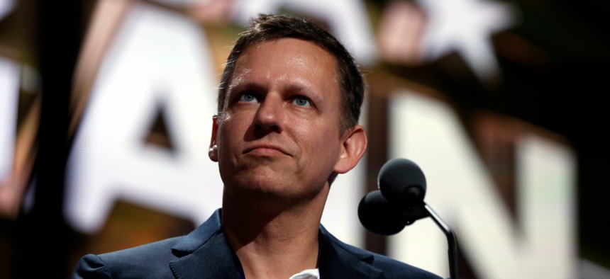 Billionaire tech investor Peter Thiel look overr the podium before the start of the second day session of the Republican National Convention in Cleveland in 2016.