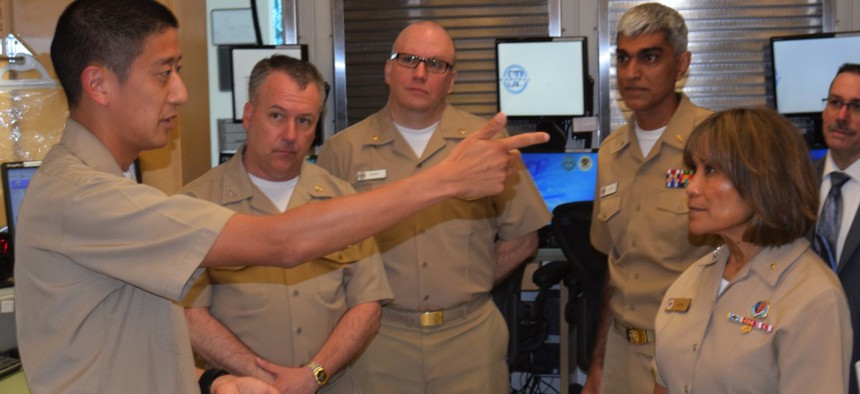 Navy Vice Adm. Raquel Bono receives candid feedback on deploying MHS GENESIS at Naval Hospital Bremerton from the command's pharmacy department head, Lt. Cmdr. Dean Kang, in June 2018.