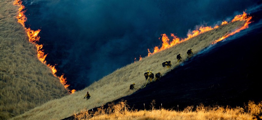 Firefighters battle the Marsh Fire near the town of Brentwood in Contra Costa County, Calif., Aug. 3.