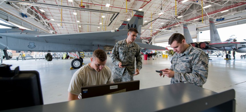 Integrated avionics technicians download data off of an F-15 Eagle's Crash Survivable Memory Unit to check flight control systems at Barnes Air National Guard Base in Massachusetts.