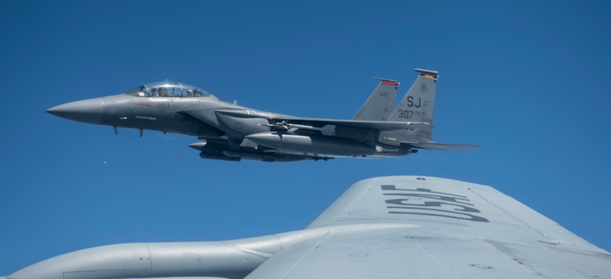 An F-15E Strike Eagle assigned to the 333rd Fighter Squadron flies next to a KC-135R Stratotanker after receiving fuel Sept. 24, 2019, near North Carolina's Outer Banks.