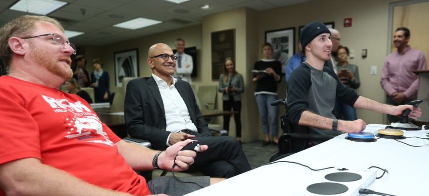 Veteran Roger Brannon, left, plays games with Microsoft CEO Satya Nadella and fellow vet  Matthew Wade.