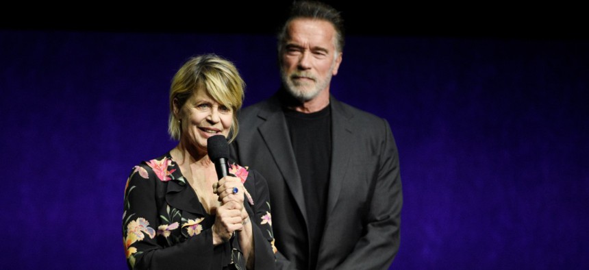 Linda Hamilton discusses "Terminator: Dark Fate" onstage as fellow cast member Arnold Schwarzenegger looks on during the Paramount Pictures presentation at CinemaCon 2019 in April.