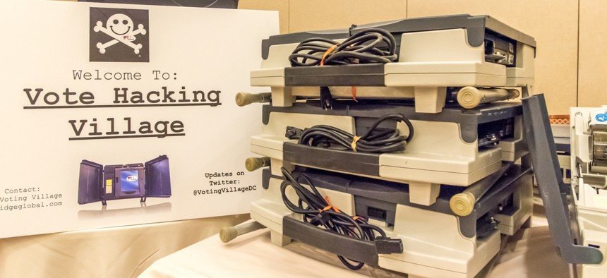 Compromised voting machines currently in use in the U.S. on display at DEFCON in April 2018. 