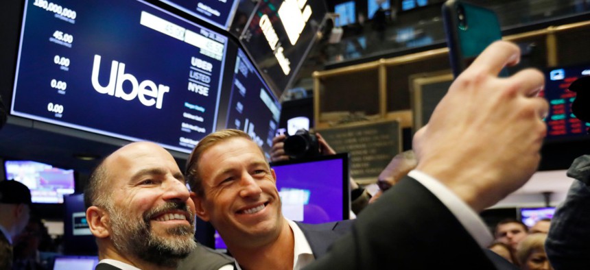 Uber CEO Dara Khosrowshahi, left, and Ryan Graves, a board member, pose for a photo before the company lists during its initial public offering at the New York Stock Exchange, May 10, 2019.