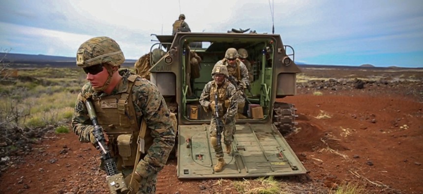 Marines exit an amphibious assault vehicle during a platoon attack as part of exercise Bougainville II on October.