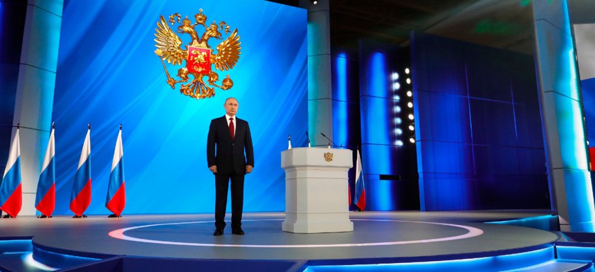 Russian President Vladimir Putin listens the national anthem after his speech to the State Council in Moscow, Russia, Wednesday, Jan. 15, 2020. 