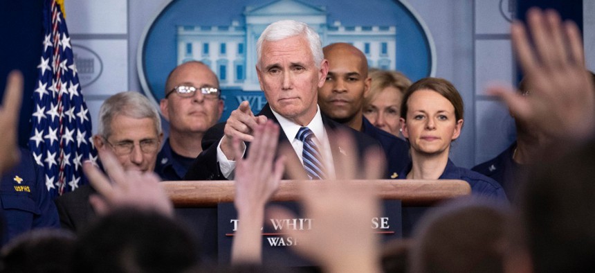 Vice President Mike Pence points to a question as he speaks during a briefing about the coronavirus in the James Brady Press Briefing Room of the White House March 15.