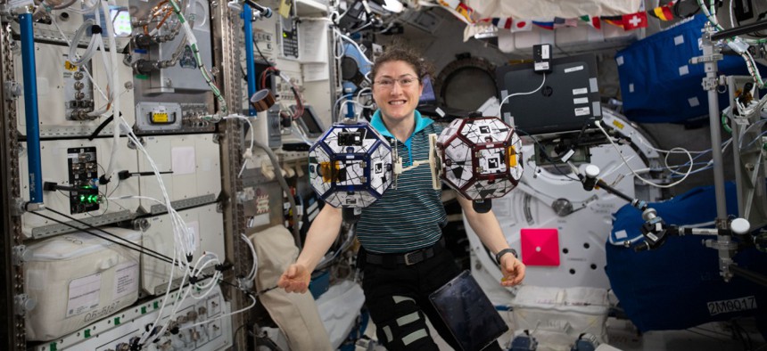 Expedition 60 Flight Engineer Christina Koch of NASA can be seen here floating with the SPHERES robots in July.