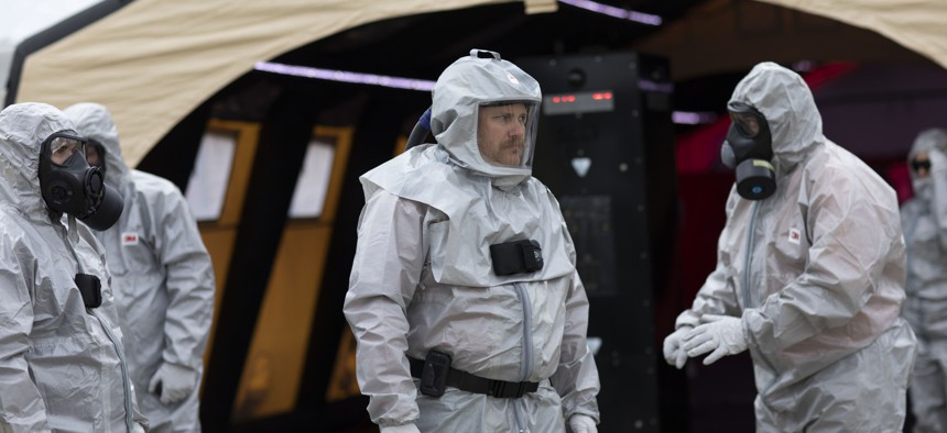 Demonstrators in hazmat suits show how technology can be used to streamline emergency communications and management at the OCR 2019 conference in Perry, Georgia.