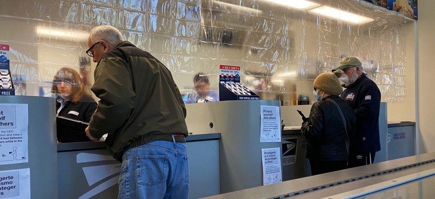 Plastic divider separating employees and customers at a Chicago post office during the Coronavirus pandemic in April.