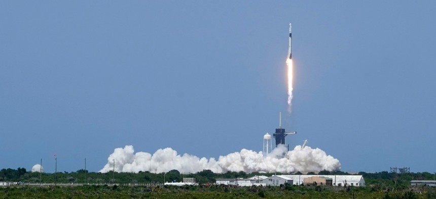 A SpaceX Falcon 9, with NASA astronauts Doug Hurley and Bob Behnken in the Crew Dragon capsule, lifts off from Pad 39-A at the Kennedy Space Center in Cape Canaveral, Fla., Saturday, May 30, 2020.