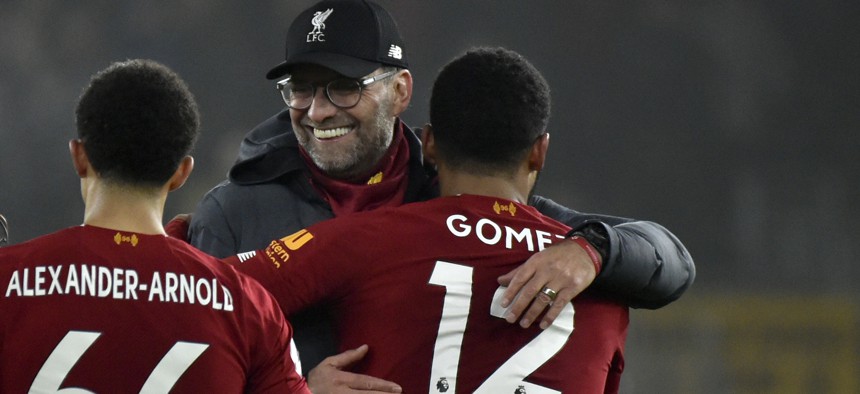 Liverpool's manager Jurgen Klopp, center, celebrates with Liverpool's Trent Alexander-Arnold, left, and Liverpool's Joe Gomez at the end of the English Premier League soccer match in January.