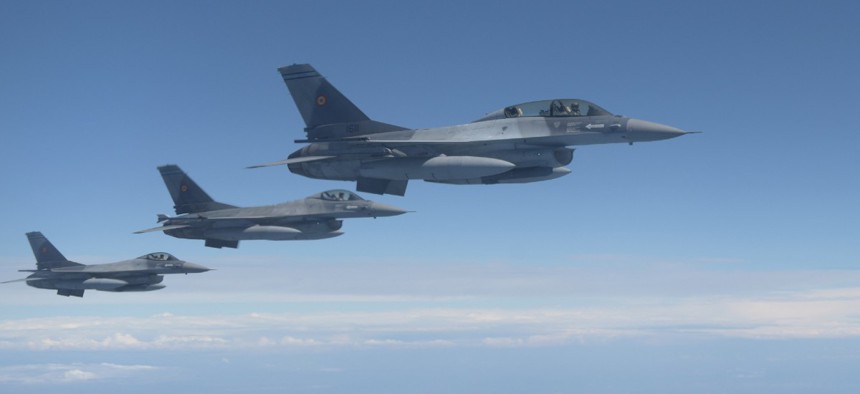Three Romanian F-16s fly alongside a U.S. Air Force KC-135 Stratotanker assigned to the 100th Air Refueling Wing, England, over Romania July 22, 2020.