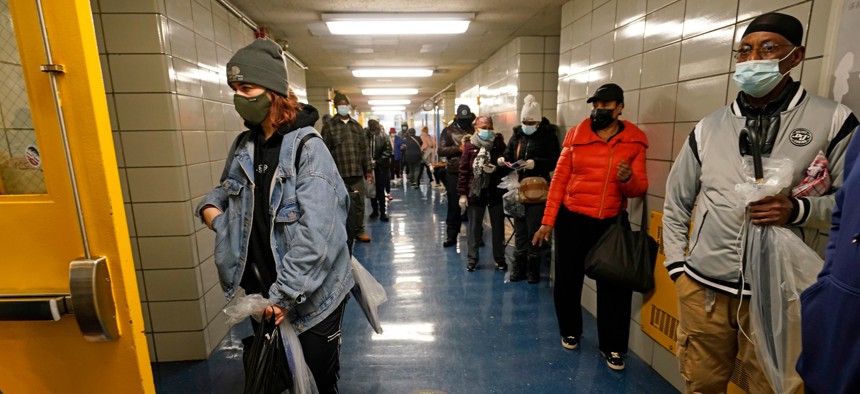 Voters wait in line in a hallway at Harlem's P.S. 175 on the last day of early voting Nov. 1, 2020, in New York.