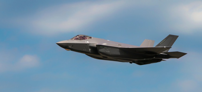 Military F35 fighter jet flying. Blue sky with clouds. Lockheed Martin F-35B "Lightning" II