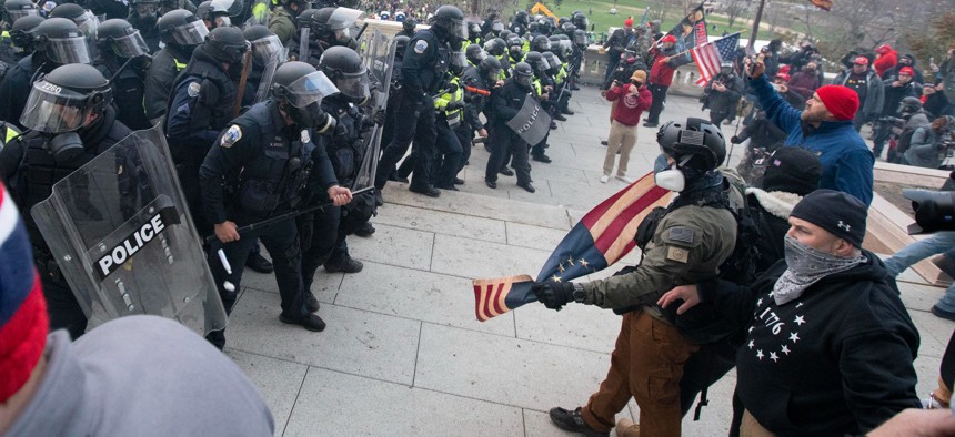 U.S. Capitol Police push back demonstrators who were trying to enter the U.S. Capitol on Wednesday, Jan. 6, 2021, in Washington. 