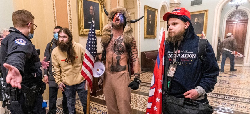 Supporters of President Donald Trump are confronted by Capitol Police officers outside the Senate Chamber inside the Capitol, Wednesday, Jan. 6, 2021 in Washington. 