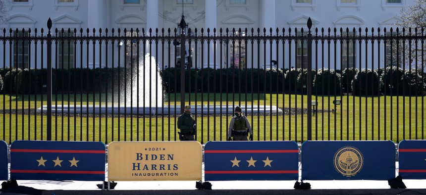 A security team patrols in front of the White House as preparations continue ahead of President-elect Joe Biden's inauguration ceremony, Tuesday, Jan. 19, 2021, in Washington. 