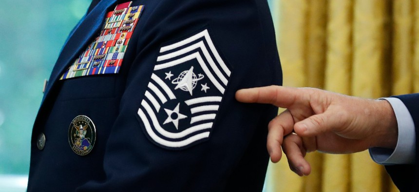 In this May 15, 2020, file photo, Chief Master Sgt. Roger Towberman displays his insignia during a presentation of the United States Space Force flag in the Oval Office of the White House in Washington.
