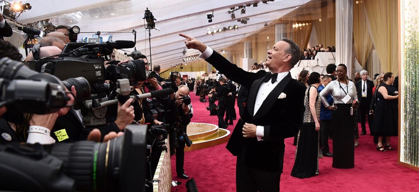 Tom Hanks arrives at the Oscars in Los Angeles on Feb. 9, 2020. Last March, Hanks disclosed that he had tested positive for the coronavirus while filming in Australia. 