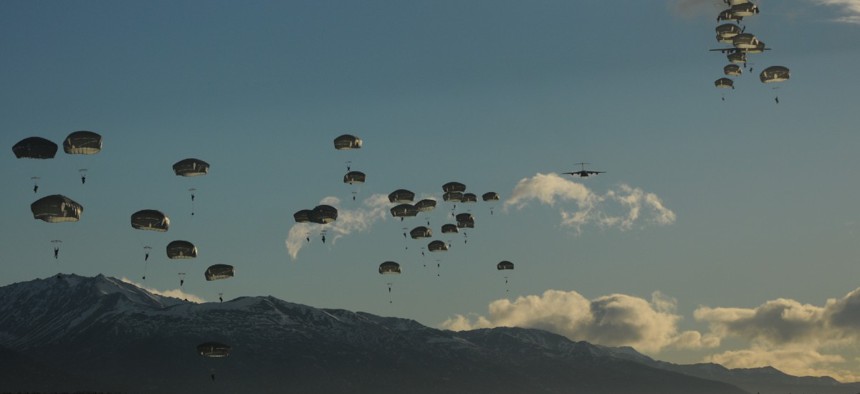 Paratroopers exit from two Air Force C-17 Globemaster III aircraft during an airborne operation on the first day of a nine-day field training exercise in 2014 at Joint Base Elmendorf-Richardson, Alaska. 