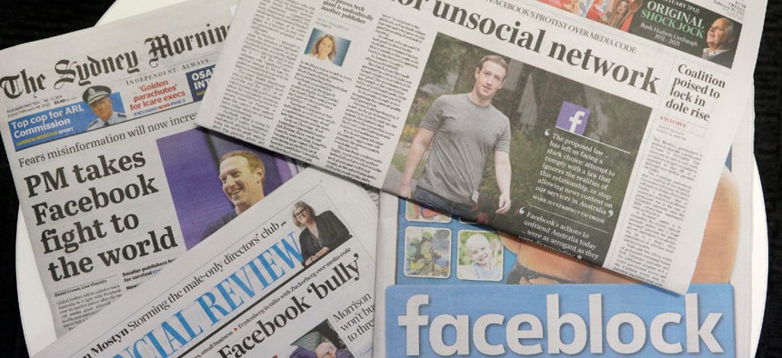 Front pages of Australian newspapers are displayed featuring stories about Facebook in Sydney Feb. 19.