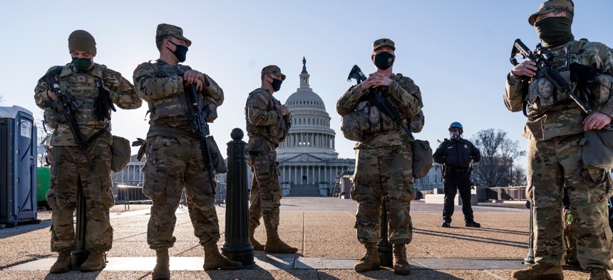 Members of the Michigan National Guard and the U.S. Capitol Police keep watch as heightened security remains in effect around the Capitol grounds since the Jan. 6 attacks by a mob of supporters of then-President Donald Trump.