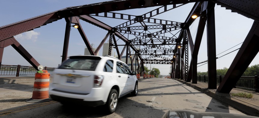 In this Sept. 11, 2013 file photo, vehicles drive on the 130th St. bridge over the Little Calumet River in Chicago that was classified as both "structurally deficient" and "fracture critical" in federal data for 2012.