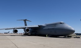 Airmen from the 60th Aerial Port Squadron prepare to load COVID-19 supplies onto a C-5M Super Galaxy as it sits on the flight line at Travis Air Force Base, California, April 28.