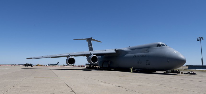 Airmen from the 60th Aerial Port Squadron prepare to load COVID-19 supplies onto a C-5M Super Galaxy as it sits on the flight line at Travis Air Force Base, California, April 28.