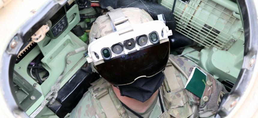 Soldier dons the Integrated Visual Augmentation System Capability Set 3 hardware while mounted on a Bradley in Joint Base Lewis-McCord.